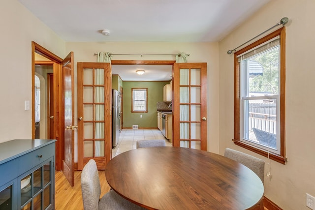 1821 Orange Ave E, Saint Paul, MN 55119 - dining space with french doors, plenty of natural light, and light wood-type flooring