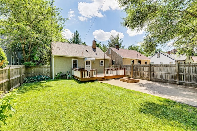 1821 Orange Ave E, Saint Paul, MN 55119 - rear view of property featuring a wooden deck, stucco siding, a fenced backyard, and a chimney
