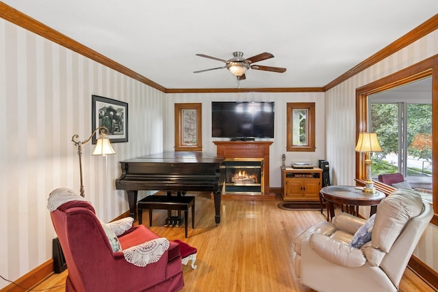 116 9th Ave NW, Rochester, MN 55901 - living area with wallpapered walls, ornamental molding, ceiling fan, light wood-type flooring, and a glass covered fireplace