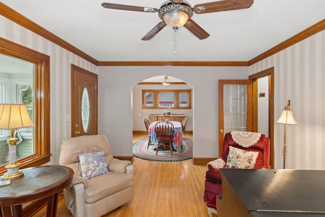 116 9th Ave NW, Rochester, MN 55901 - living area with light wood finished floors, crown molding, arched walkways, ceiling fan, and wallpapered walls