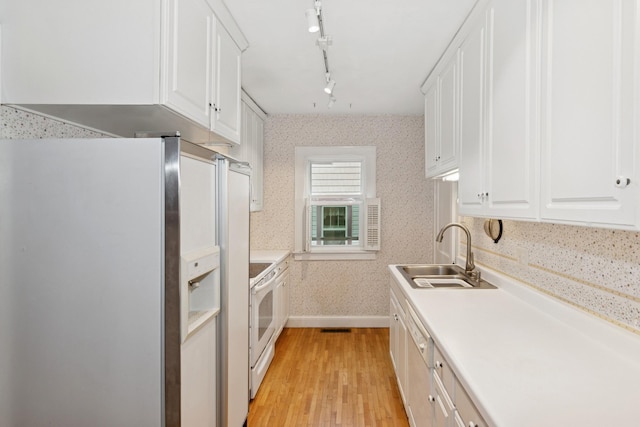 116 9th Ave NW, Rochester, MN 55901 - kitchen with white appliances, light wood-style floors, white cabinets, light countertops, and wallpapered walls
