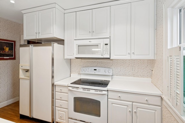 116 9th Ave NW, Rochester, MN 55901 - kitchen with white appliances, wallpapered walls, white cabinetry, light countertops, and wood finished floors