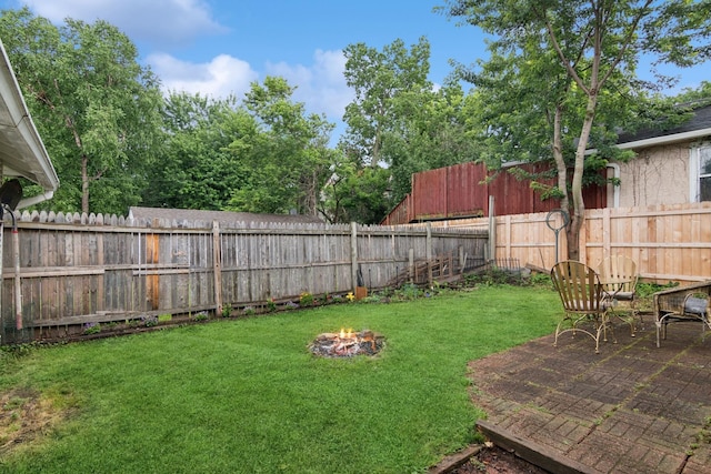 116 9th Ave NW, Rochester, MN 55901 - fenced backyard featuring an outdoor fire pit and a patio area