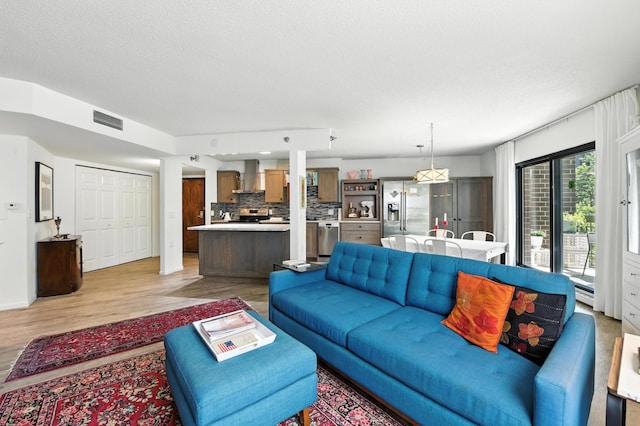 6615 Lake Shore Dr S Unit 317, Richfield, MN 55423 - living room featuring light wood-type flooring and a textured ceiling