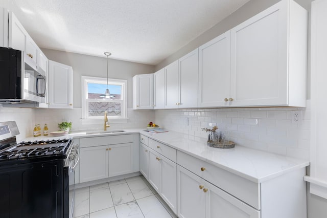1634 Upton Ave N, Minneapolis, MN 55411 - kitchen featuring appliances with stainless steel finishes, light marble finish flooring, light stone countertops, white cabinetry, and a textured ceiling