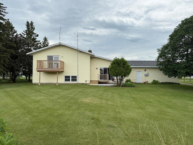 31044 Acorn Lake Rd, Frazee, MN 56544 - back of house with a lawn and a balcony