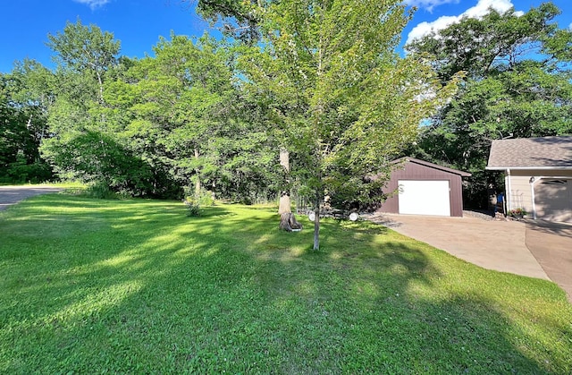 39631 342nd Ln, Aitkin, MN 56431 - view of green lawn featuring an outdoor structure, concrete driveway, and a garage