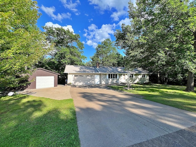 39631 342nd Ln, Aitkin, MN 56431 - single story home with concrete driveway, a front yard, an outbuilding, a garage, and a chimney