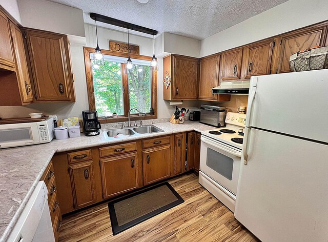 39631 342nd Ln, Aitkin, MN 56431 - kitchen featuring white appliances, under cabinet range hood, light wood finished floors, light countertops, and a textured ceiling