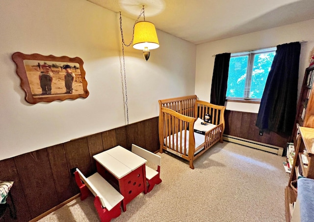 39631 342nd Ln, Aitkin, MN 56431 - carpeted bedroom featuring baseboard heating, a wainscoted wall, wooden walls, and a crib