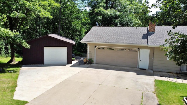 39631 342nd Ln, Aitkin, MN 56431 - view of front facade with a chimney, a shingled roof, an outbuilding, and a garage