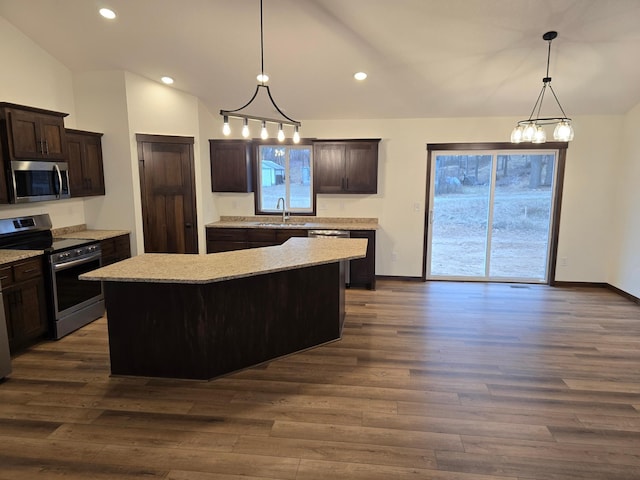 10815 190th Ln NW, Elk River, MN 55330 - kitchen featuring stainless steel appliances, vaulted ceiling, dark brown cabinets, dark wood finished floors, and a center island