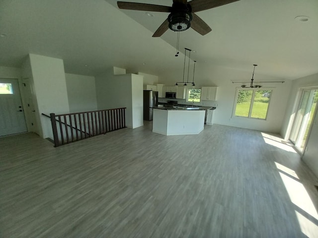 1267 146th Ave, New Richmond, WI 54017 - unfurnished living room with light wood-type flooring, a ceiling fan, and high vaulted ceiling
