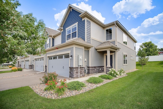 6450 Inspire Cir S, Cottage Grove, MN 55016 - view of front of home featuring an attached garage, driveway, and stone siding