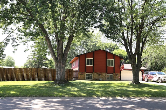 8301 Sumter Ave N, Brooklyn Park, MN 55445 - view of side of home featuring a garage, brick siding, and concrete driveway