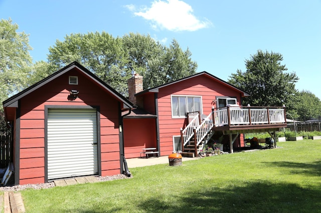 8301 Sumter Ave N, Brooklyn Park, MN 55445 - back of house with a wooden deck, a chimney, a lawn, stairs, and an outbuilding