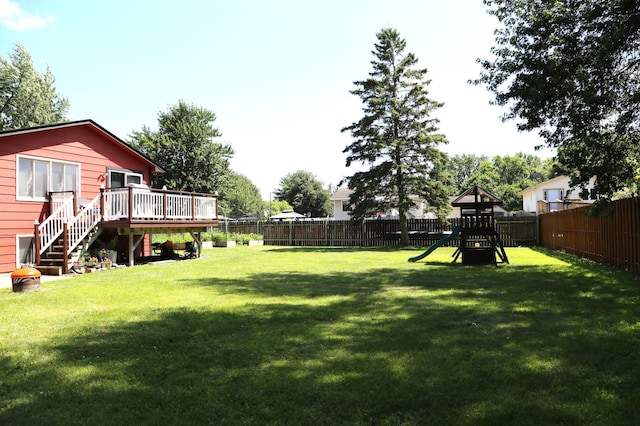8301 Sumter Ave N, Brooklyn Park, MN 55445 - fenced backyard featuring a wooden deck, a playground, and stairway