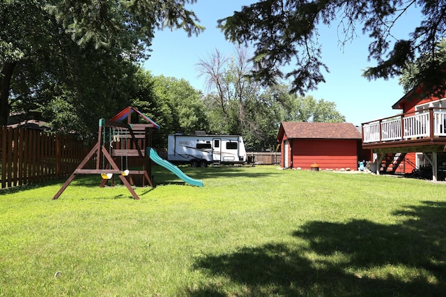 8301 Sumter Ave N, Brooklyn Park, MN 55445 - fenced backyard with stairway, a playground, and a wooden deck