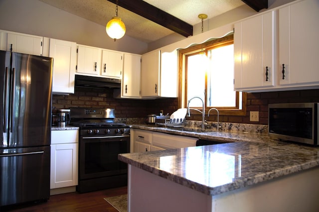 8301 Sumter Ave N, Brooklyn Park, MN 55445 - kitchen featuring freestanding refrigerator, black gas range oven, under cabinet range hood, stainless steel microwave, and beam ceiling