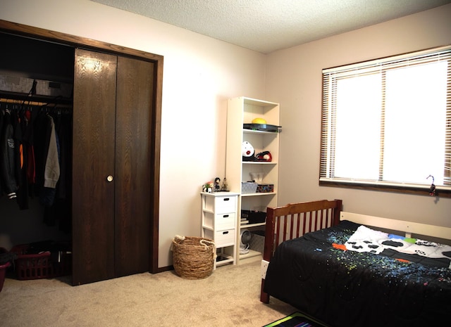 8301 Sumter Ave N, Brooklyn Park, MN 55445 - carpeted bedroom featuring a closet and a textured ceiling