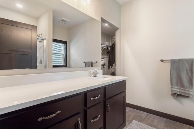 2065 Pleasant Dr, Prescott, WI 54021 - bathroom with vanity, a shower with shower door, and a spacious closet