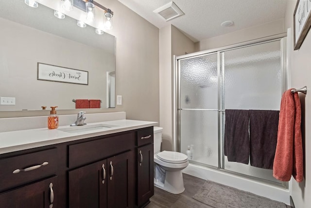 2065 Pleasant Dr, Prescott, WI 54021 - full bath with vanity, a shower stall, wood finished floors, and a textured ceiling