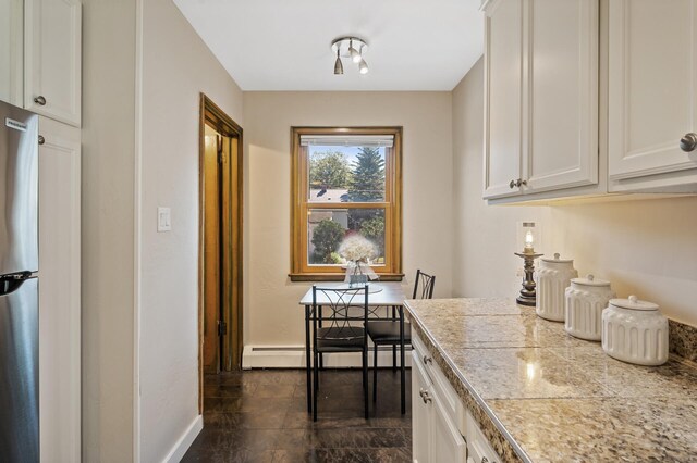 5321 Park Ave, Minneapolis, MN 55417 - kitchen featuring white cabinetry, a baseboard heating unit, and tile counters