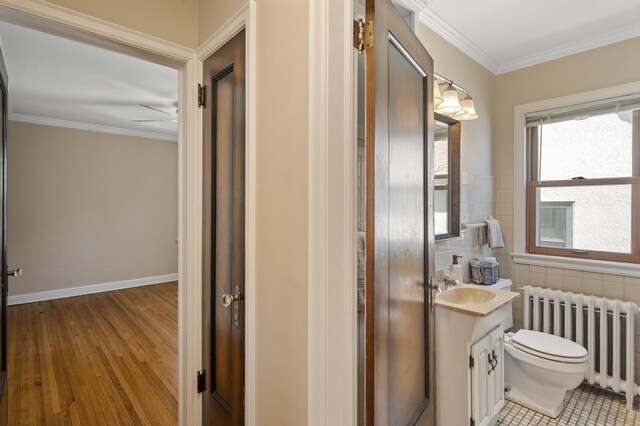 5321 Park Ave, Minneapolis, MN 55417 - half bathroom featuring radiator heating unit, vanity, ornamental molding, wood finished floors, and ceiling fan