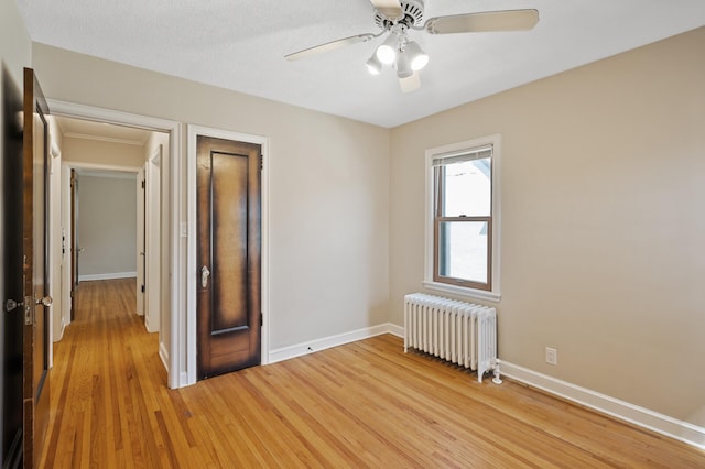 5321 Park Ave, Minneapolis, MN 55417 - unfurnished bedroom with radiator, light wood finished floors, and ceiling fan