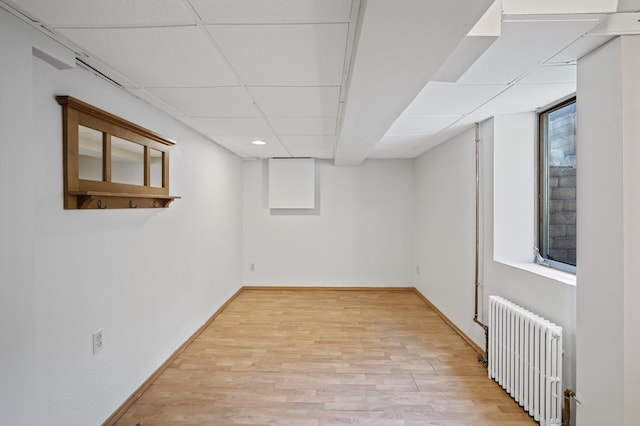 5321 Park Ave, Minneapolis, MN 55417 - basement featuring radiator, light wood-type flooring, and a drop ceiling