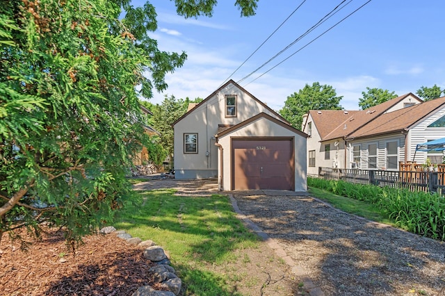 5321 Park Ave, Minneapolis, MN 55417 - view of front of home featuring dirt driveway, stucco siding, and a garage