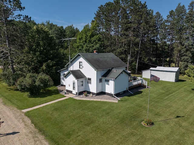 6770 County Road 65 NE, Deer River, MN 56636 - view of property exterior with a lawn, roof with shingles, and an outbuilding