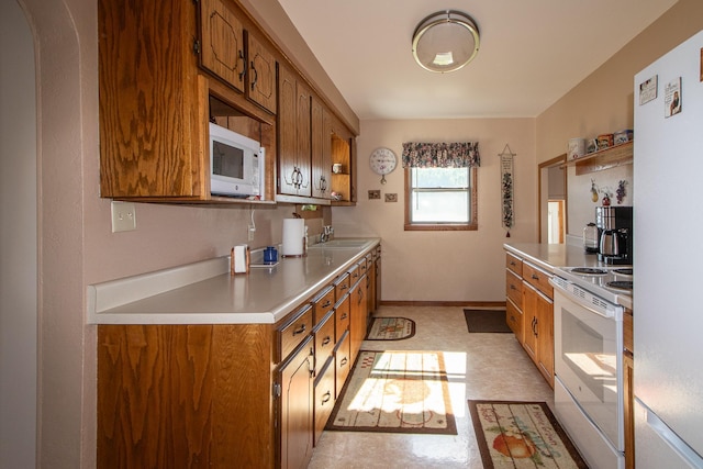 6770 County Road 65 NE, Deer River, MN 56636 - kitchen featuring white appliances, brown cabinetry, light countertops, and light flooring
