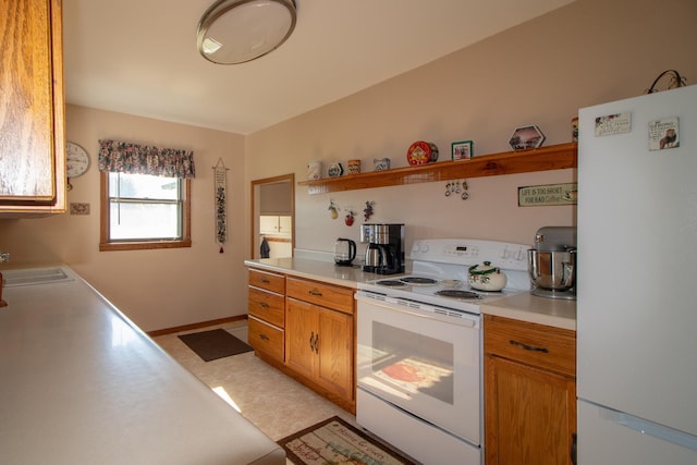 6770 County Road 65 NE, Deer River, MN 56636 - kitchen with white appliances, light countertops, open shelves, and brown cabinetry