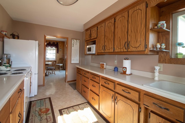 6770 County Road 65 NE, Deer River, MN 56636 - kitchen with white appliances, brown cabinetry, light countertops, light floors, and open shelves