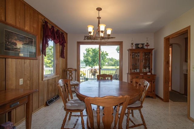 6770 County Road 65 NE, Deer River, MN 56636 - dining space featuring light flooring, a chandelier, and wooden walls