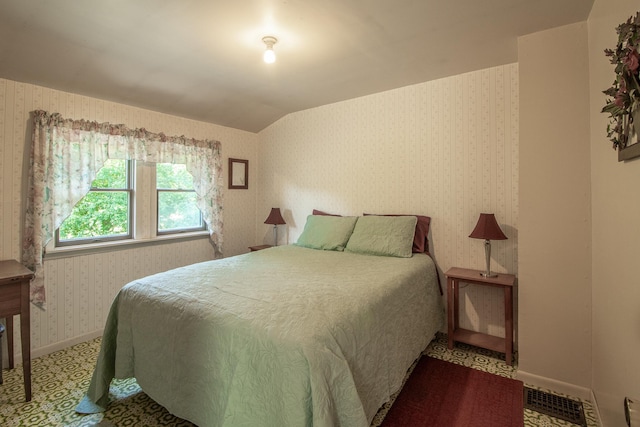6770 County Road 65 NE, Deer River, MN 56636 - bedroom featuring wallpapered walls and lofted ceiling