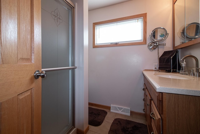 6770 County Road 65 NE, Deer River, MN 56636 - full bathroom featuring vanity, a shower with door, and tile patterned flooring