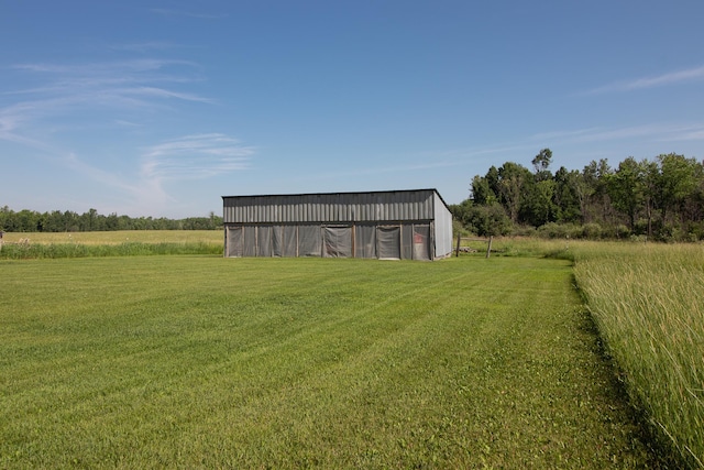 6770 County Road 65 NE, Deer River, MN 56636 - view of green lawn with a pole building, an outbuilding, and a view of rural / pastoral area