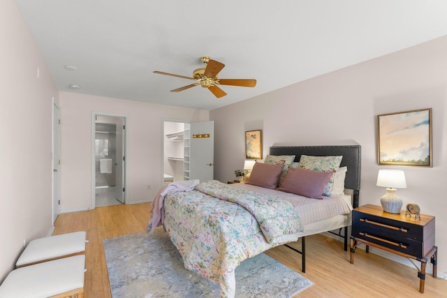 4380 Brookside Ct Unit 103, Edina, MN 55436 - bedroom featuring light wood finished floors, a spacious closet, a ceiling fan, and connected bathroom