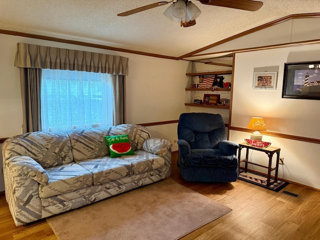 14 Silvers Resort, Elysian, MN 56028 - living area featuring wood finished floors, a ceiling fan, a textured ceiling, crown molding, and lofted ceiling