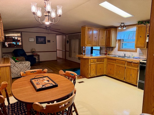 14 Silvers Resort, Elysian, MN 56028 - kitchen featuring ceiling fan, range, light countertops, a peninsula, and a chandelier