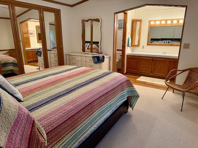 14 Silvers Resort, Elysian, MN 56028 - bedroom with ensuite bathroom, light carpet, and crown molding