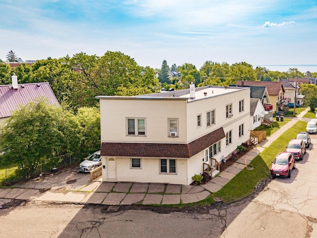 702 11th St, Duluth, MN 55805 - rear view of property featuring a chimney and a shingled roof