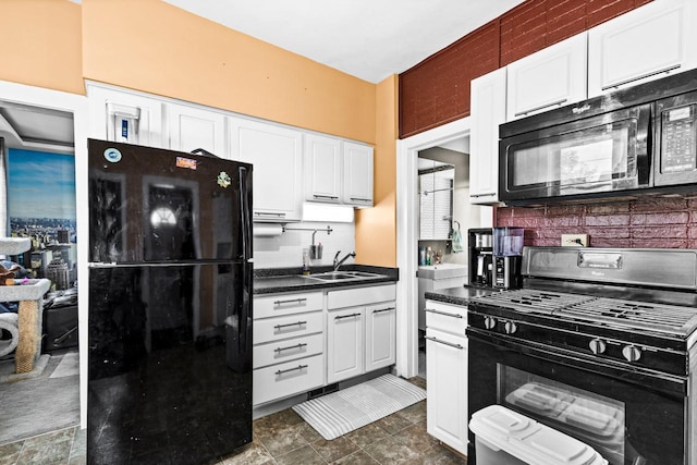 702 11th St, Duluth, MN 55805 - kitchen with black appliances, dark countertops, white cabinets, and backsplash