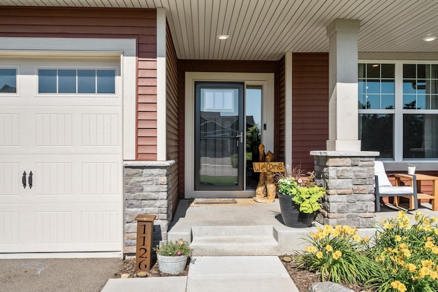 1126 Stonebridge Path, Jordan, MN 55352 - doorway to property featuring a porch, stone siding, and a garage