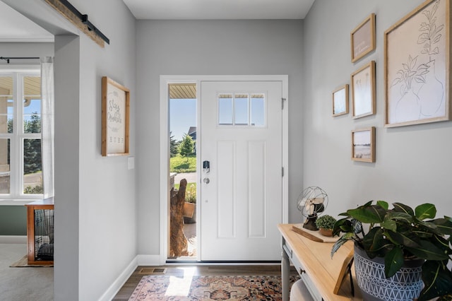 1126 Stonebridge Path, Jordan, MN 55352 - entrance foyer featuring a barn door and wood finished floors