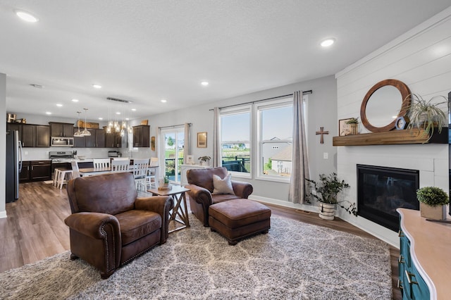 1126 Stonebridge Path, Jordan, MN 55352 - living area featuring wood finished floors, a fireplace, and recessed lighting
