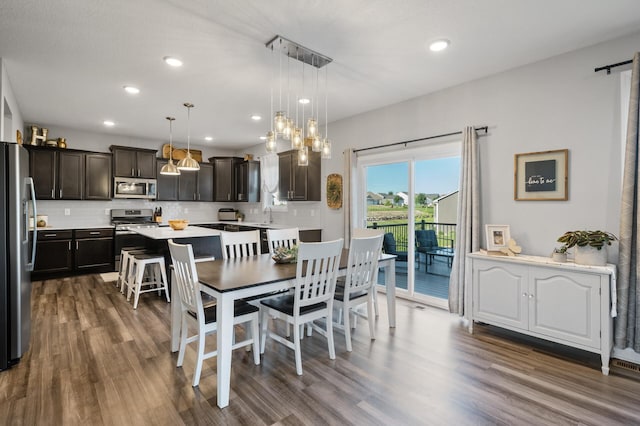 1126 Stonebridge Path, Jordan, MN 55352 - dining area featuring dark wood finished floors, recessed lighting, a chandelier, and a barn door