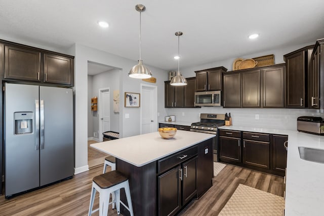 1126 Stonebridge Path, Jordan, MN 55352 - kitchen featuring stainless steel appliances, light countertops, wood finished floors, dark brown cabinetry, and recessed lighting